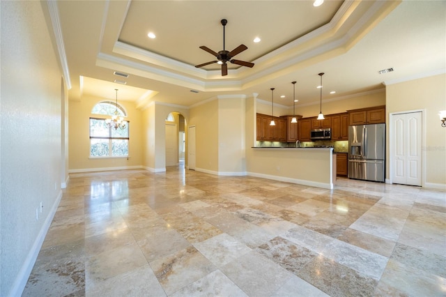 unfurnished living room with arched walkways, a raised ceiling, ceiling fan with notable chandelier, ornamental molding, and recessed lighting