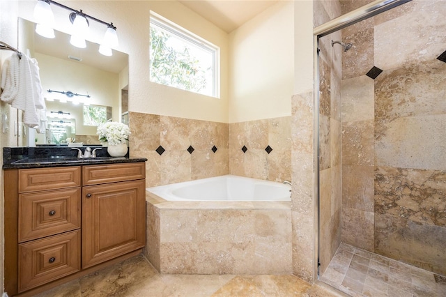 bathroom with vanity, a tile shower, a garden tub, and tile walls