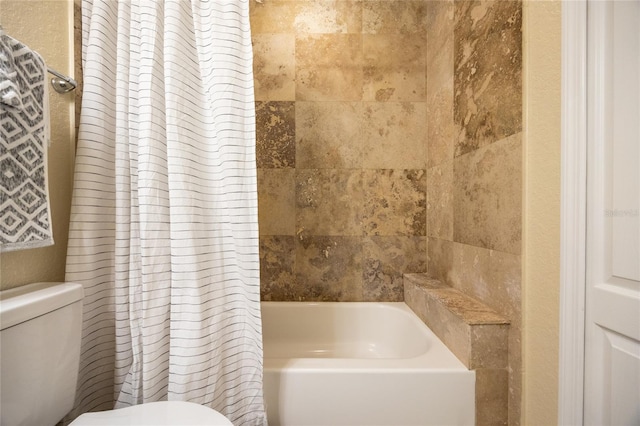 full bathroom featuring toilet and shower / bath combination with curtain