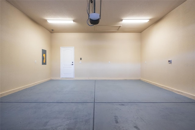 garage with baseboards, a garage door opener, and electric panel