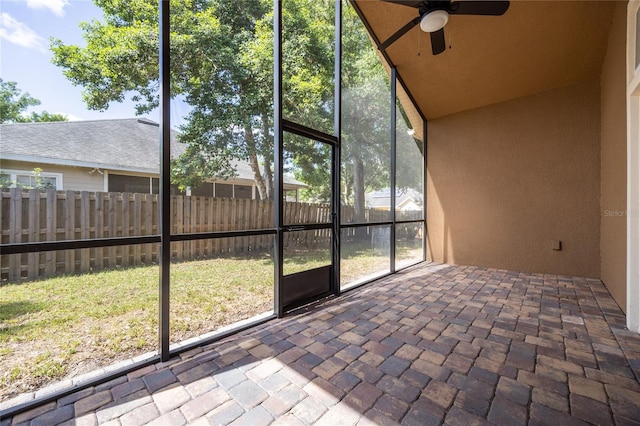 unfurnished sunroom featuring ceiling fan