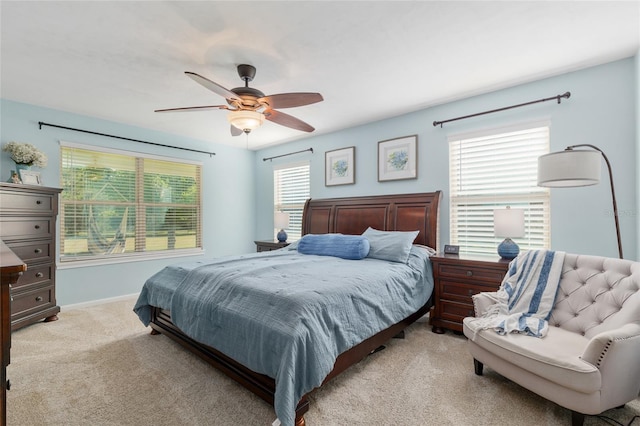 carpeted bedroom with baseboards and a ceiling fan