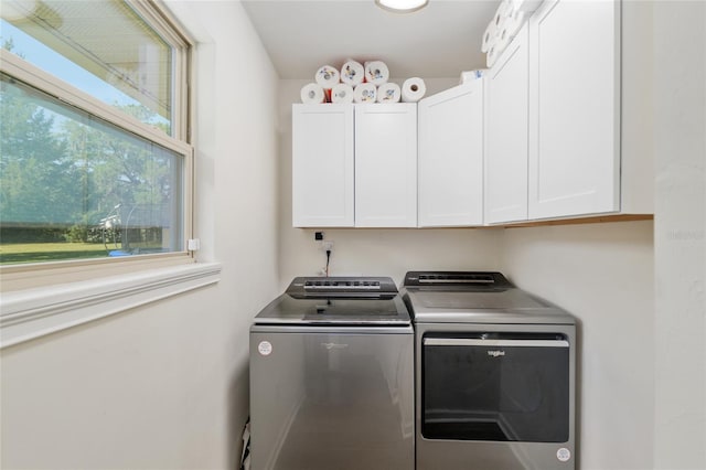 washroom with cabinet space and washing machine and clothes dryer