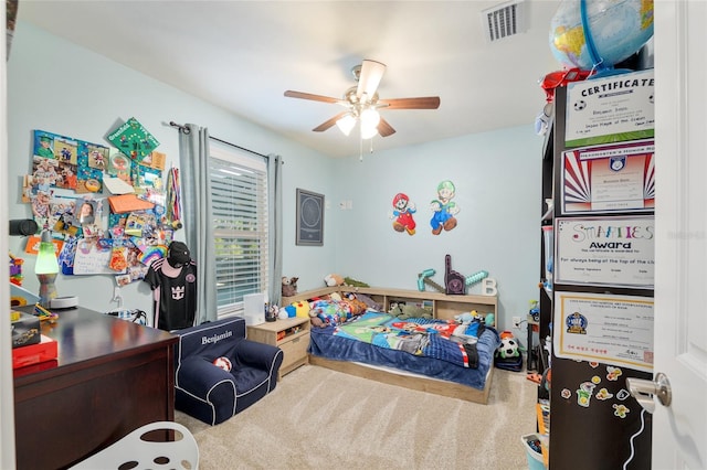 carpeted bedroom with visible vents and ceiling fan