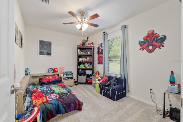 carpeted bedroom featuring baseboards, a ceiling fan, and visible vents