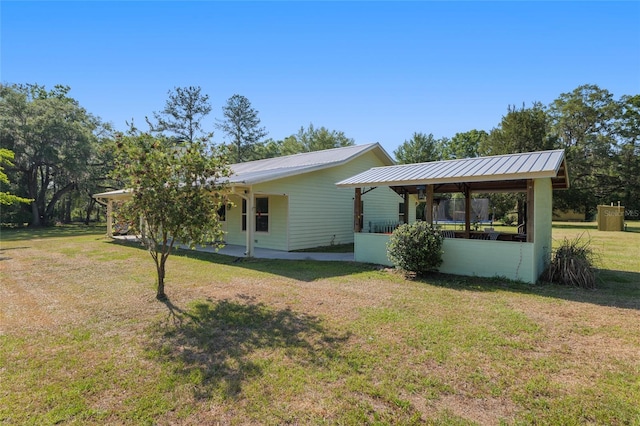 exterior space with a lawn and metal roof