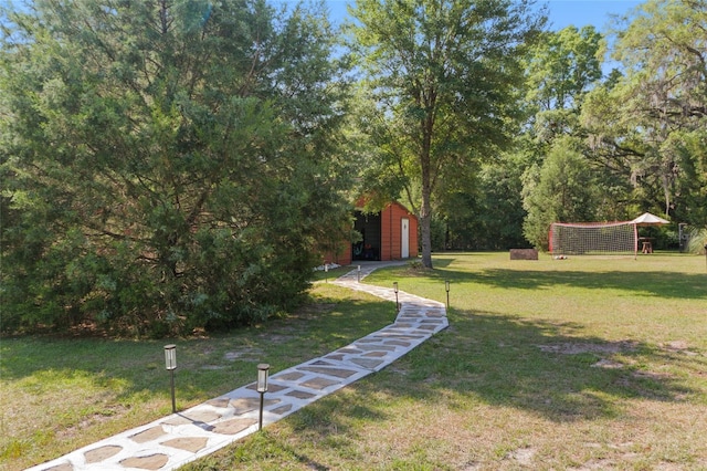view of yard featuring an outdoor structure and a shed