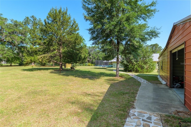 view of yard featuring a patio and a trampoline