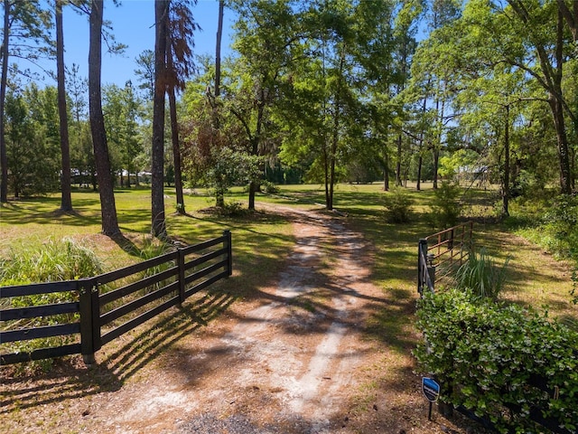 view of community with fence and a yard