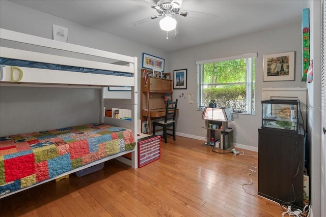 bedroom with wood-type flooring and baseboards