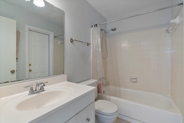 full bath featuring shower / bath combo with shower curtain, toilet, and vanity