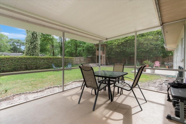 sunroom / solarium featuring outdoor dining space