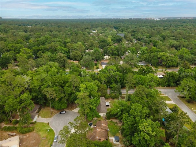 birds eye view of property with a view of trees