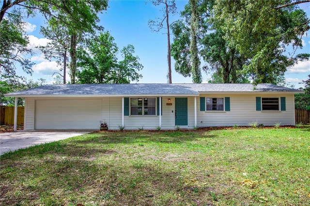 single story home with fence, an attached garage, driveway, and a front lawn