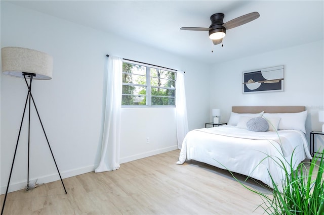 bedroom with baseboards, a ceiling fan, and wood finished floors
