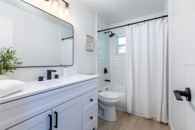 full bathroom featuring vanity, toilet, wood finished floors, and shower / tub combo