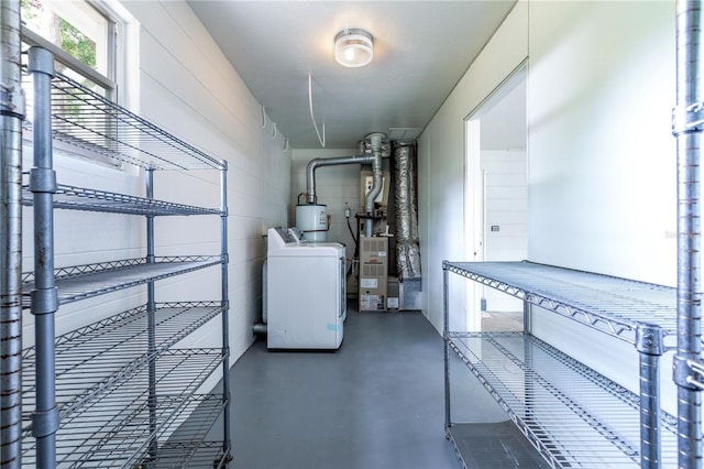 utilities featuring washer / dryer, water heater, and heating unit