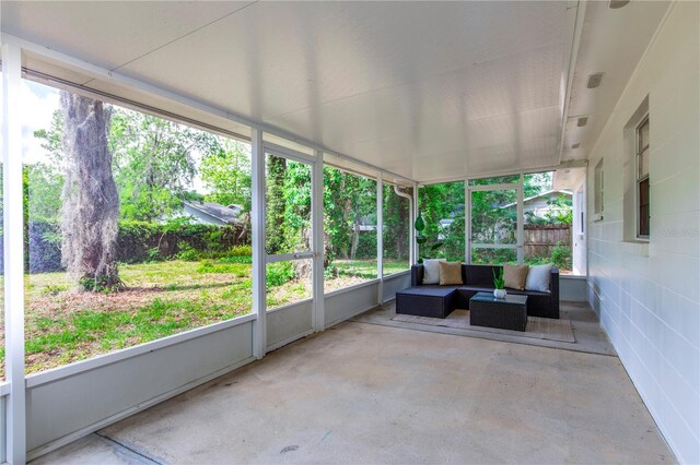 sunroom / solarium with an outdoor living space and a wealth of natural light
