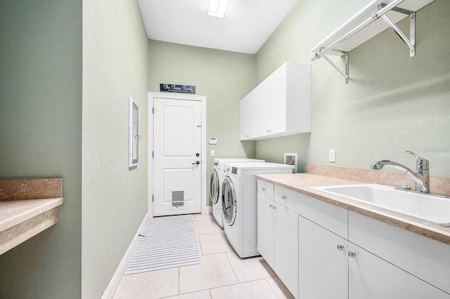 clothes washing area featuring independent washer and dryer, cabinet space, a sink, light tile patterned floors, and baseboards