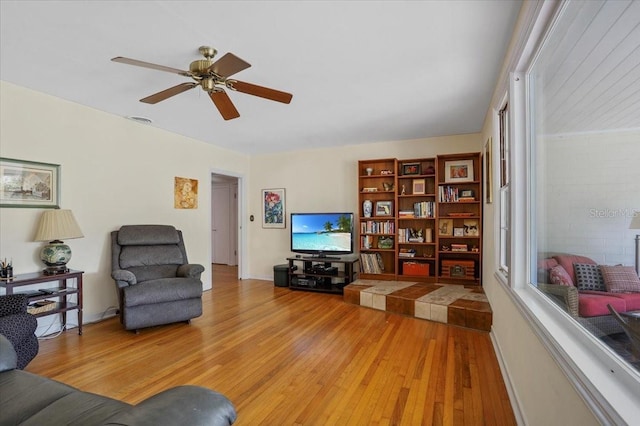 living room featuring light wood-style floors and ceiling fan