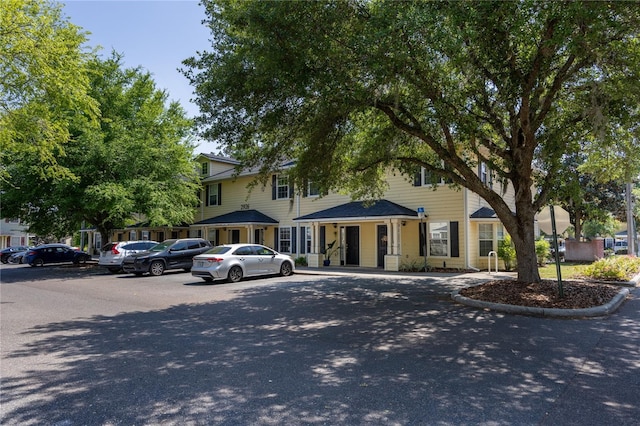 view of property featuring uncovered parking