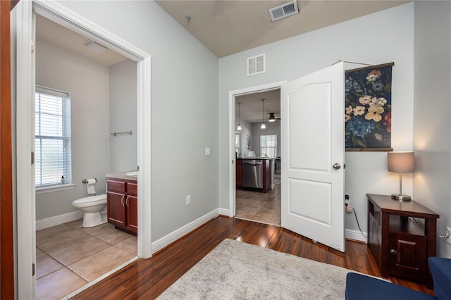 interior space with baseboards, dark wood-type flooring, and visible vents