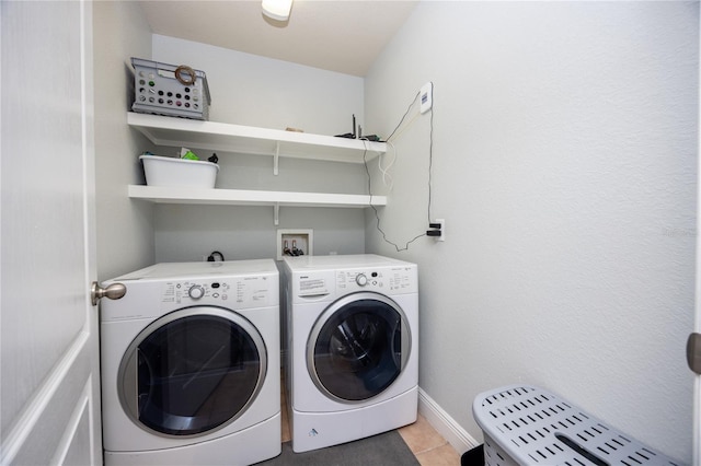 laundry room with baseboards, separate washer and dryer, laundry area, and light tile patterned floors