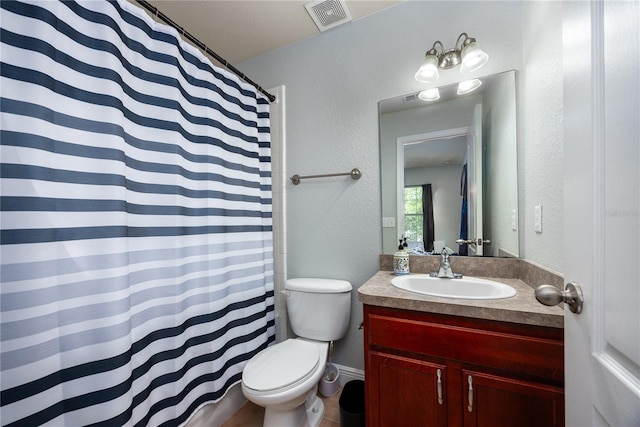 bathroom with a textured wall, vanity, toilet, a shower with curtain, and visible vents