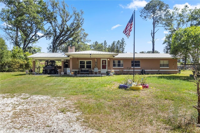 1529 NW 143rd St, Gainesville, FL 32606 - rear view of house with a carport, a lawn, a chimney, and metal roof