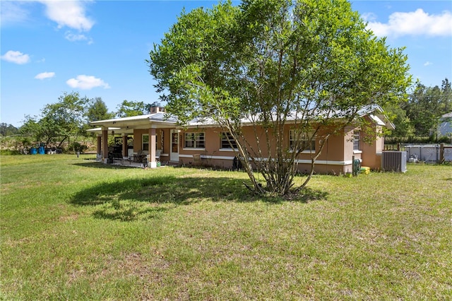 1529 NW 143rd St, Gainesville, FL 32606 - back of property with central air condition unit, a patio, and stucco siding
