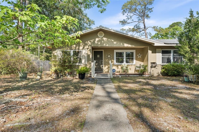 5620 NW 25th St, Gainesville, FL 32653 - bungalow-style house featuring solar panels and covered porch
