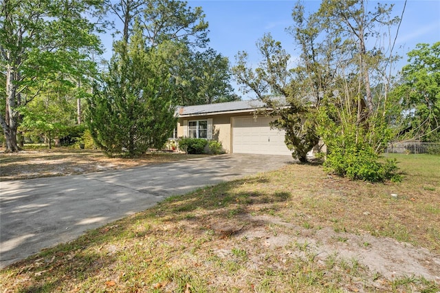 5620 NW 25th St, Gainesville, FL 32653 - view of property hidden behind natural elements with concrete driveway and an attached garage