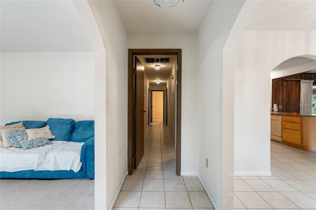 5620 NW 25th St, Gainesville, FL 32653 - corridor featuring light tile patterned floors, visible vents, baseboards, and arched walkways