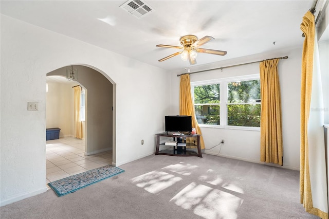 5620 NW 25th St, Gainesville, FL 32653 - empty room with arched walkways, carpet, visible vents, and a ceiling fan