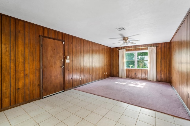 5620 NW 25th St, Gainesville, FL 32653 - empty room with ceiling fan, light carpet, visible vents, and wood walls