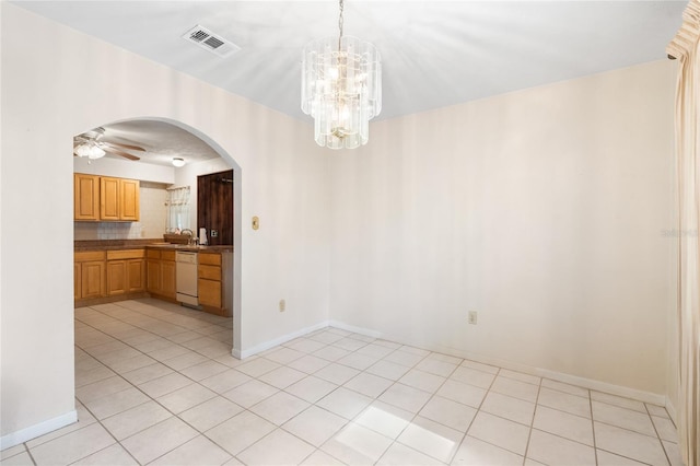 5620 NW 25th St, Gainesville, FL 32653 - unfurnished dining area featuring light tile patterned floors, visible vents, a sink, ceiling fan with notable chandelier, and arched walkways