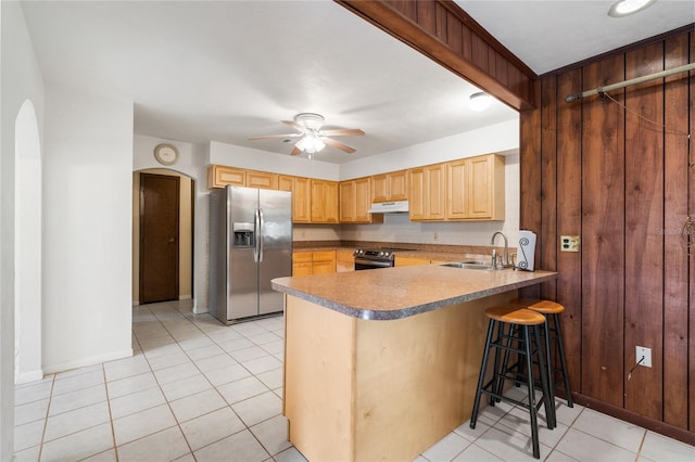 5620 NW 25th St, Gainesville, FL 32653 - kitchen featuring a peninsula, a ceiling fan, a sink, under cabinet range hood, and appliances with stainless steel finishes