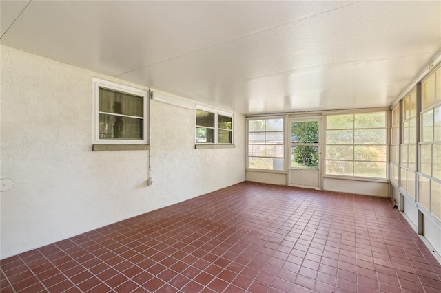 5620 NW 25th St, Gainesville, FL 32653 - unfurnished sunroom featuring tile patterned flooring and a textured wall