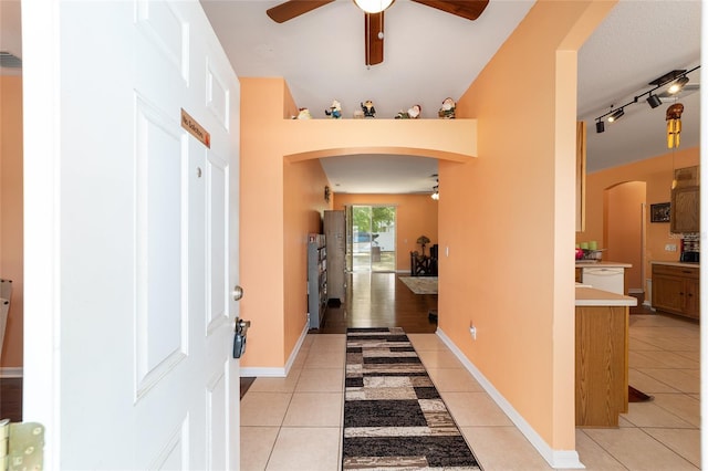2648 NE 24th Pl, Ocala, FL 34470 - entrance foyer with arched walkways, ceiling fan, baseboards, and light tile patterned flooring