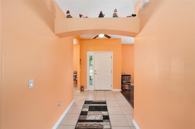 2648 NE 24th Pl, Ocala, FL 34470 - foyer featuring baseboards, arched walkways, a ceiling fan, and light tile patterned floors