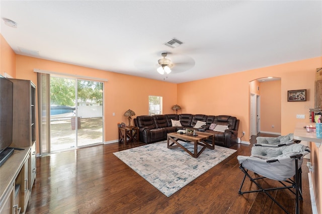 2648 NE 24th Pl, Ocala, FL 34470 - living room featuring visible vents, baseboards, ceiling fan, arched walkways, and dark wood finished floors