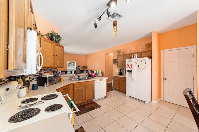 2648 NE 24th Pl, Ocala, FL 34470 - kitchen with visible vents, a sink, light countertops, light tile patterned floors, and white appliances