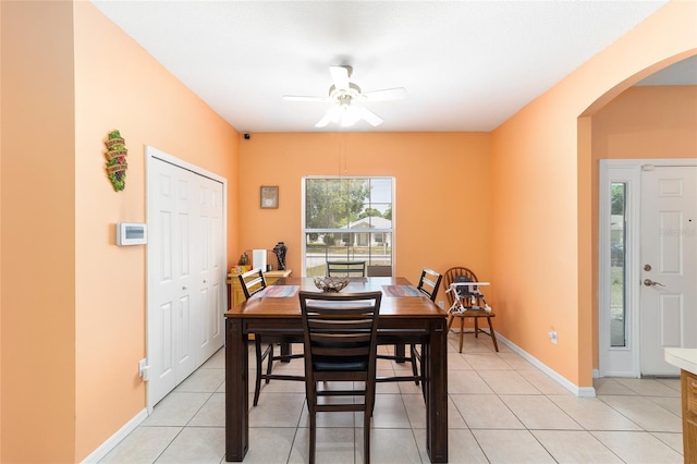 2648 NE 24th Pl, Ocala, FL 34470 - dining area with baseboards, arched walkways, a ceiling fan, and light tile patterned floors