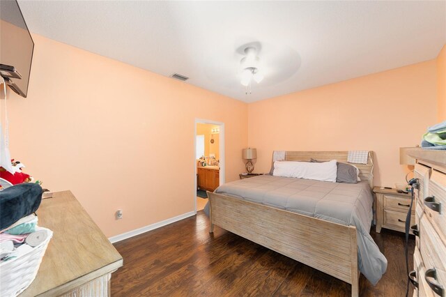 2648 NE 24th Pl, Ocala, FL 34470 - bedroom featuring visible vents, baseboards, ensuite bathroom, dark wood-style floors, and a ceiling fan