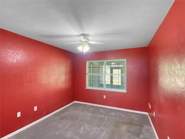 spare room featuring carpet floors, baseboards, and a ceiling fan