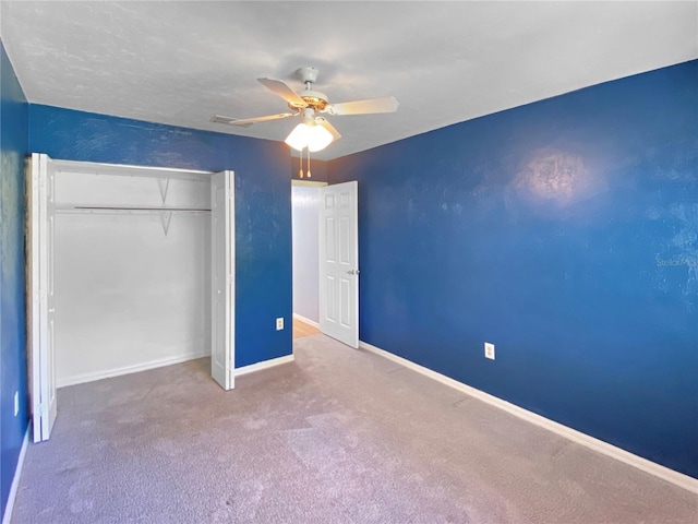 unfurnished bedroom featuring a closet, visible vents, baseboards, ceiling fan, and carpet