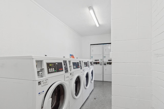 shared laundry area featuring ornamental molding, stacked washer and dryer, and separate washer and dryer
