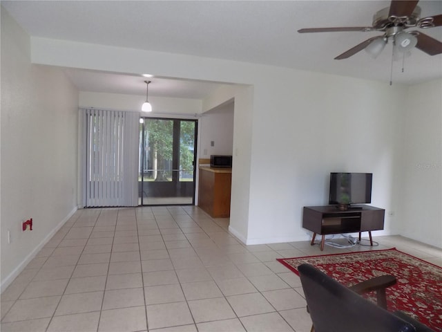 2811 SW Archer Rd Unit W 191, Gainesville, FL 32608 - living room with light tile patterned flooring, ceiling fan, and baseboards