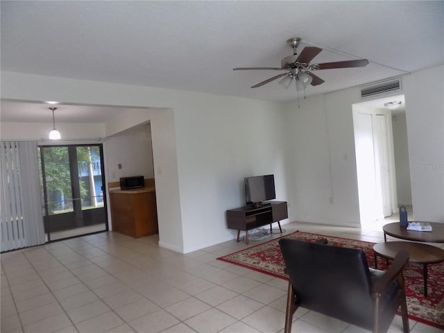 2811 SW Archer Rd Unit W 191, Gainesville, FL 32608 - living room featuring ceiling fan, light tile patterned flooring, and baseboards
