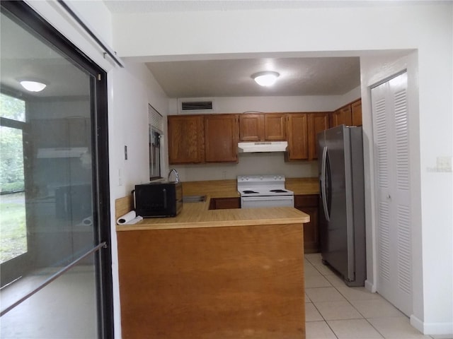 2811 SW Archer Rd Unit W 191, Gainesville, FL 32608 - kitchen featuring freestanding refrigerator, electric stove, under cabinet range hood, brown cabinetry, and light tile patterned flooring